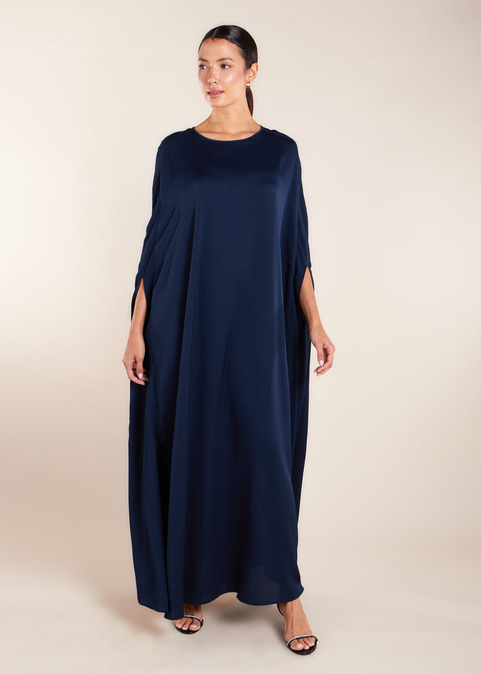 Add a touch of elegance to your wardrobe with our Crinkled Kaftan Navy. Made from a lightweight soft crinkle non-crease fabric, this gown is perfect for warmer weather. Dark blue loose fit kaftan