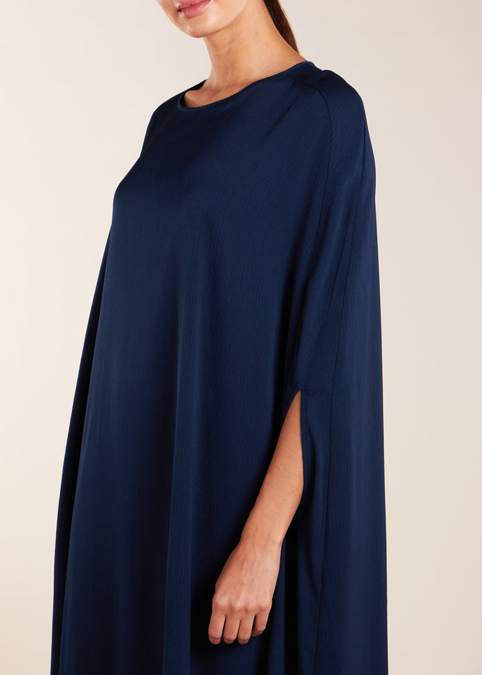 Add a touch of elegance to your wardrobe with our Crinkled Kaftan Navy. Made from a lightweight soft crinkle non-crease fabric, this gown is perfect for warmer weather. Dark blue loose fit kaftan