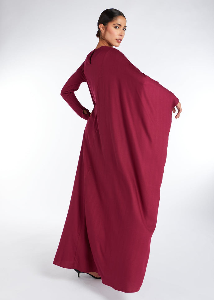 Designed with an asymmetric style and voluminous silhouette, it's an ideal choice for any special occasion. The deep berry hue adds a touch of sophistication, while the limited edition nature ensures a true-to-size fit.