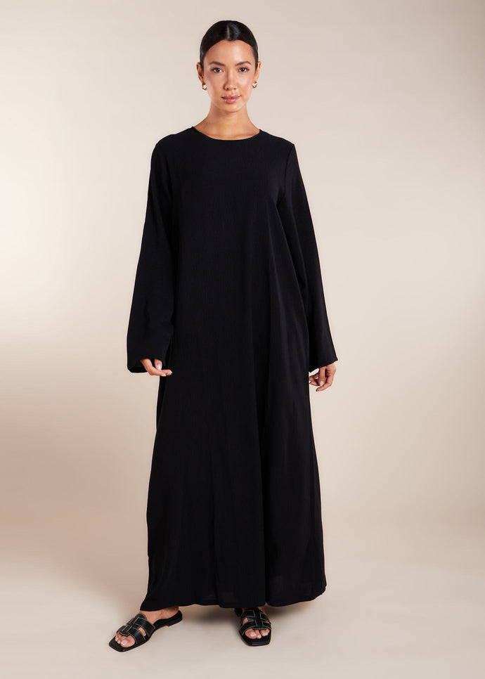 This elegant Two Piece Open Abaya set includes a Full Sleeve matching inner dress. Perfect for everyday wear, it can also be dressed up with accessories for an evening look. The open abaya can be worn as a maxi on its own or paired with the inner dress for a stylish ensemble. In black.