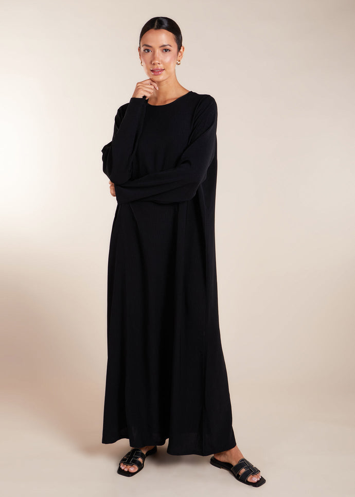 This elegant Two Piece Open Abaya set includes a Full Sleeve matching inner dress. Perfect for everyday wear, it can also be dressed up with accessories for an evening look. The open abaya can be worn as a maxi on its own or paired with the inner dress for a stylish ensemble. In black.