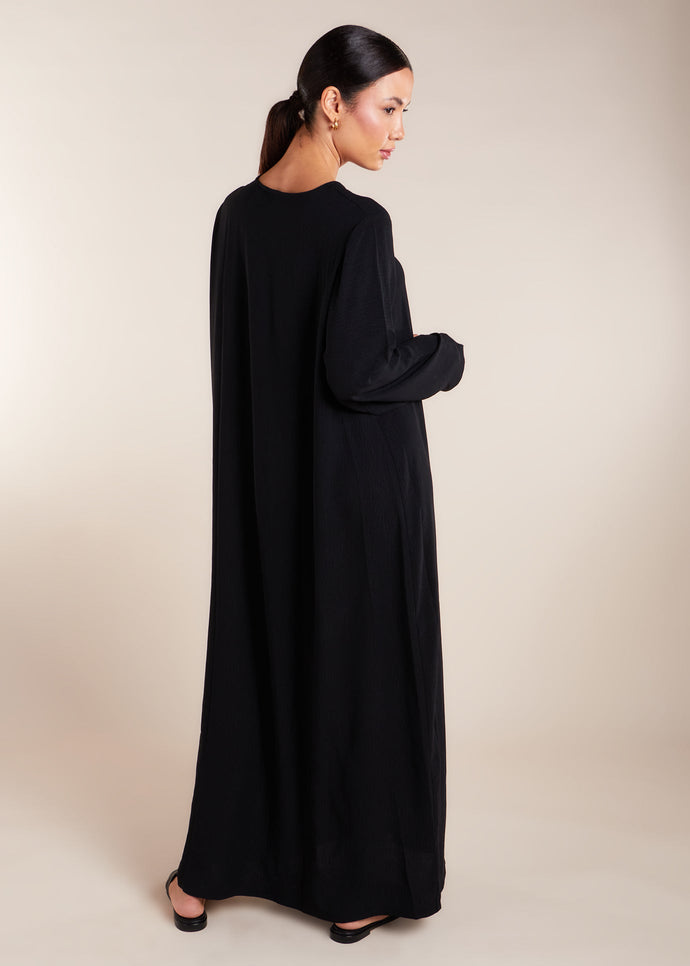 This elegant Two Piece Open Abaya set includes a Full Sleeve matching inner dress. Perfect for everyday wear, it can also be dressed up with accessories for an evening look. The open abaya can be worn as a maxi on its own or paired with the inner dress for a stylish ensemble. In black.